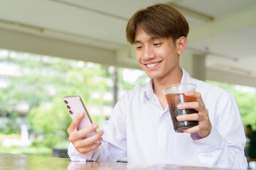 Non binary university student sitting in college campus