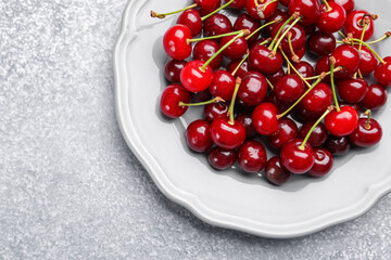 Fresh ripe cherries on light table, top view