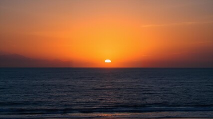 A stunning sunset is captured over calm waters