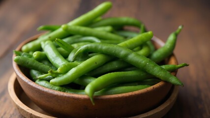 A wooden bowl filled with green beans