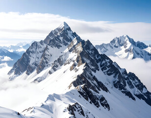 Obraz premium Majestic snow-capped peaks rise dramatically above a sea of clouds under a clear blue sky
