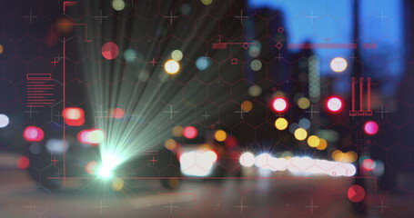 Flaring vehicle headlights lighting street at night, with bokeh taillights and red hex grid overlay