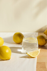 a cold clear glass of lemonade on the table illuminated by a bright light