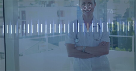 Standing worker in scrubs and monitoring digital waveform in hospital lobby wristwatch, copy space