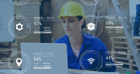 Helmeted logistics worker updating inventory on laptop at warehouse station, with order graphics