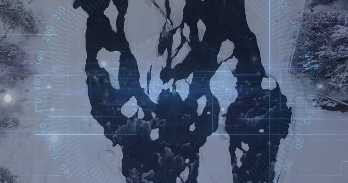 Fototapeta Revealing snow-covered landscape unfolding in winter forest, with winding river and evergreen trees