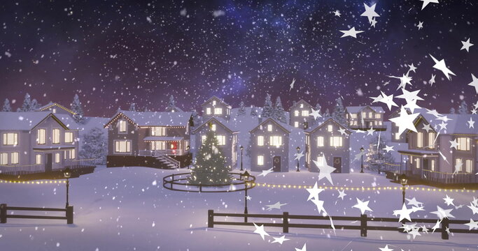 Glowing Christmas tree standing in village plaza at night with railing, string lights and lampposts