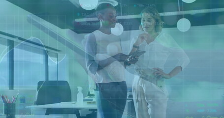 Two professional women reviewing financial data on tablet in modern office, with desk and monitor