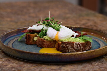 close up serving avocado toast with egg