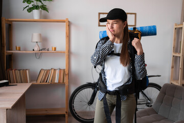 Teeth problem. traveler hiker with backpack feeling tooth pain at home. Dental health and care...