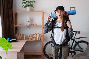 creative talented hiker woman with backpack ready to hiking suggesting great idea, raise finger up...