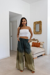 Latina model posing in the living room wearing a summer outfit.
