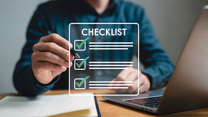 Businessman reviewing tasks on a virtual checklist with laptop to maintain organization, productivity, and ensure successful project management, staying on schedule and track.