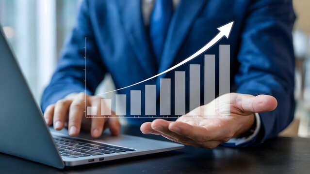Corporate professional showcasing growth chart while using laptop, representing business development and financial strategy for wealth building and investment returns. - Powered by Adobe