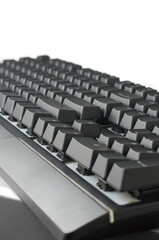 side view of black mechanical gaming keyboard isolated white background, showing height and slope of the keys, designed for intense gaming or typing performance