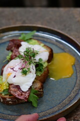 close up serving avocado toast with egg