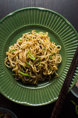 top view of fried ramen noodles with sesame and sliced peppers
