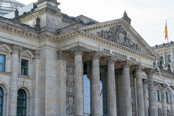 Front view of the Reichstag building with the inscription To the German People. The neoclassical architecture has a monumental effect
