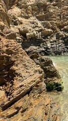 Fototapeta premium Rocky Coastline and Gentle Sea Waves – Tranquil Nature Background