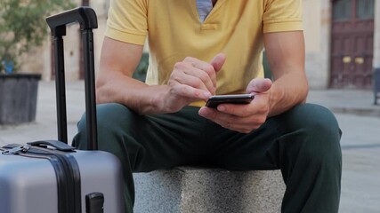 A person is using their smartphone outdoors in a vibrant urban setting, enjoying connectivity - Powered by Adobe