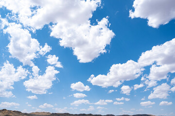 White airy clouds in a blue sky. Summer fluffy clouds, Beautiful sky with clouds, background for your projects.