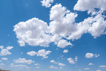 White airy clouds in a blue sky. Summer fluffy clouds, Beautiful sky with clouds, background for your projects.