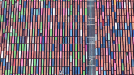 Long Beach, United States - 07 April 2025: Aerial view of a sea of colorful shipping containers, neatly stacked like vibrant building blocks.