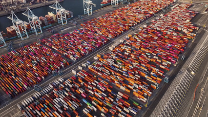 Port of Oakland, United States - 07 April 2025: Aerial view of countless shipping containers creating a vibrant mosaic of colors, stretching across the port's vast expanse.