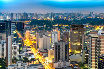 The immense scale of Sao Paulo, Brazil, captured from above, with endless high-rises under a twilight sky.