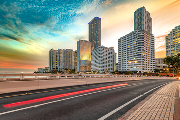 The dynamic skyline of Brickell, Downtown Miami, Florida, ablaze with lights against a dramatic sunset sky.