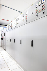An electrical switchgear room at a substation, showcasing rows of control panels and essential power infrastructure.