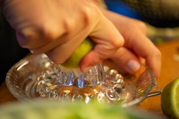 A vivid macro shot capturing a woman slicing a fresh lemon and squeezing its juice over a colorful...