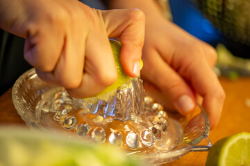 A vivid macro shot capturing a woman slicing a fresh lemon and squeezing its juice over a colorful...