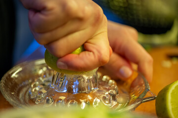 A vivid macro shot capturing a woman slicing a fresh lemon and squeezing its juice over a colorful...