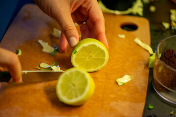 A vivid macro shot capturing a woman slicing a fresh lemon and squeezing its juice over a colorful...