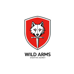 Obraz premium A stylized logo featuring a white wolf's head atop a red shield, pierced by a sword, for a creative agency.