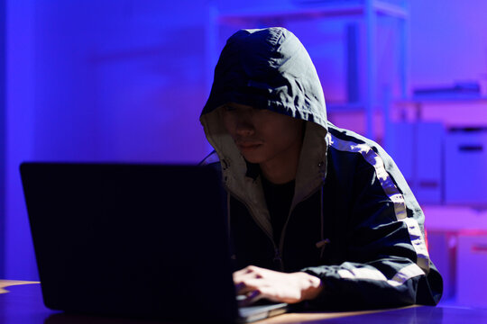 Hacker executing cyberattack to breach data and compromise digital security