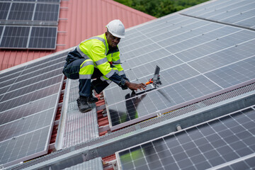 Service engineer checking solar cell on the roof for maintenance if there is a damaged part. Engineer worker install solar panel. Clean energy concept.