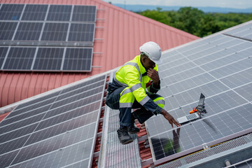 Service engineer checking solar cell on the roof for maintenance if there is a damaged part....