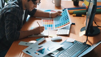 Professional designer writing and designing logo graphic at meeting. Closeup of business man...