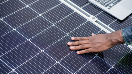 Service engineer checking solar cell on the roof for maintenance if there is a damaged part....