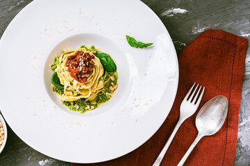 Fituccine pasta with balanese sauce and basil and pine nuts with pesto sauce. Top view. High...