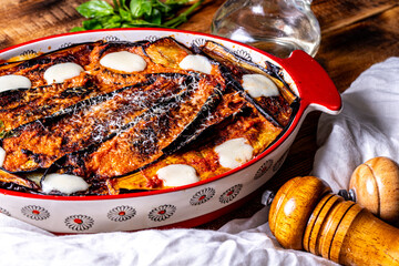 Italian cuisine: delicious macro Melanzane alla parmigiana in a baking dish. Background for using...