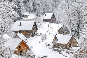 Snow-covered rustic cabins in a winter wonderland mountain village