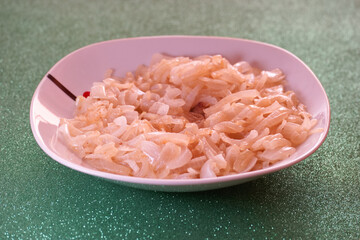 Delicate shredded coconut served on a plate at a tropical gathering in warm weather