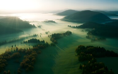 Golden sunbeams pierce through morning mist illuminating rolling green hills and valleys creating a tranquil landscape of natural beauty and peaceful serenity