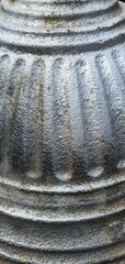 Close-up of a fluted antique iron column with weathered texture and industrial detailing. Ideal for...