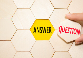 Answer or Question symbol. Concept word Answer or Question on wooden comb puzzle. Beautiful yellow...