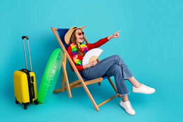 Funny woman relaxing in a wooden deck chair with colorful props and summer attire against a vibrant...