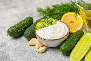 Cucumber sour cream tzatziki sauce on a wooden table.Tartar sauce. Traditional delicious appetizer....